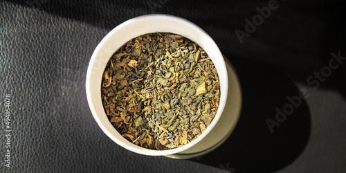 green tea dried petals flavored tea sprinkled to prepare a hot drink fresh portion healthy meal food diet snack on the table copy space food background rustic top view