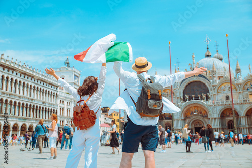 couple holding italian flag venice central square san marco photo