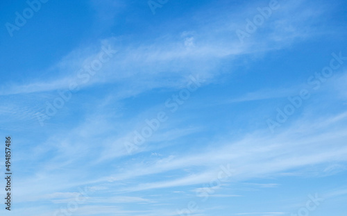 Blue sky with a thin white cloud