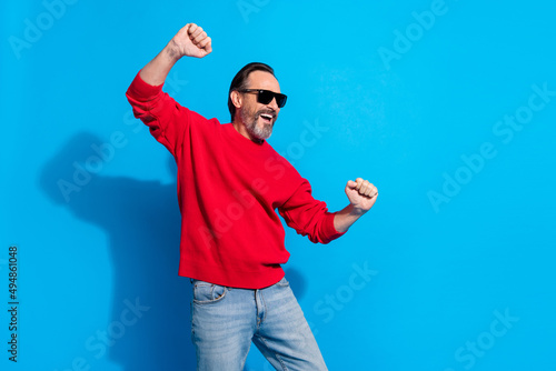 Photo of excited smiling man feeling young dancing spend free time holidays in club isolated on blue color background