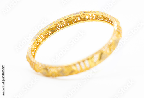 gold jewelry bracelet over on white background