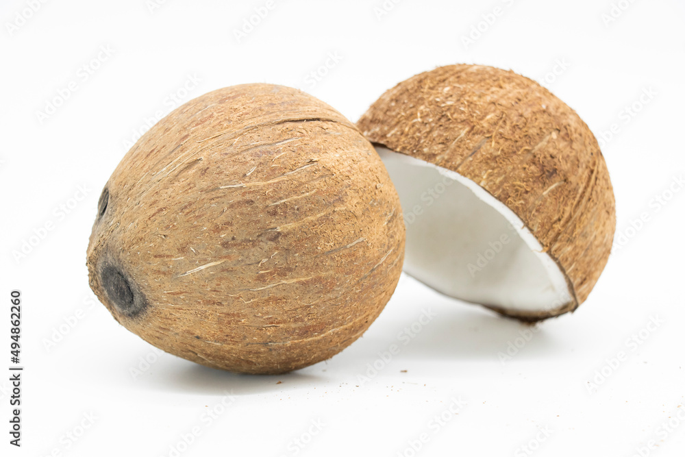 Whole coconut and pieces of coconut on white background Whole coconut and pieces of coconut on white background