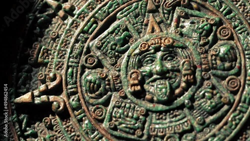Close-up slow motion camera panning around an old Mayan calendar