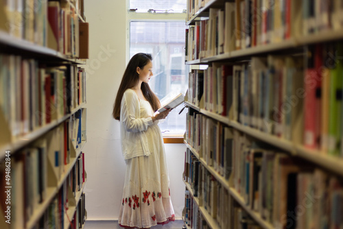 asian stylish young university school lady research student read book in library