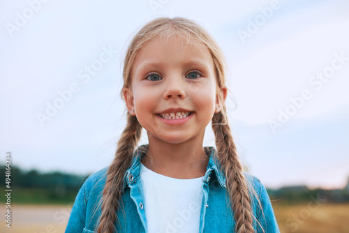 Canvastavla Close-up portrait of funny little girl with pigtails outdoor in summer day