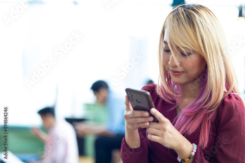 Portrait young beautiful hipster woman using smart phone. Business woman working in modern office.