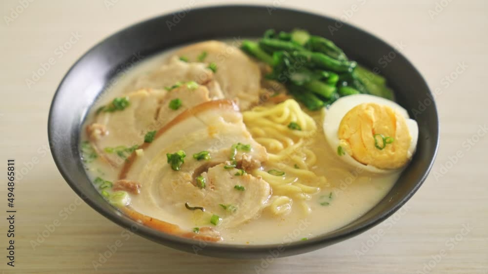Ramen noodles in pork bone soup with roast pork and egg or Tonkotsu ramen noodles - Japanese food style Ramen noodles in pork bone soup with roast pork and egg or Tonkotsu ramen noodles - Japanese food style