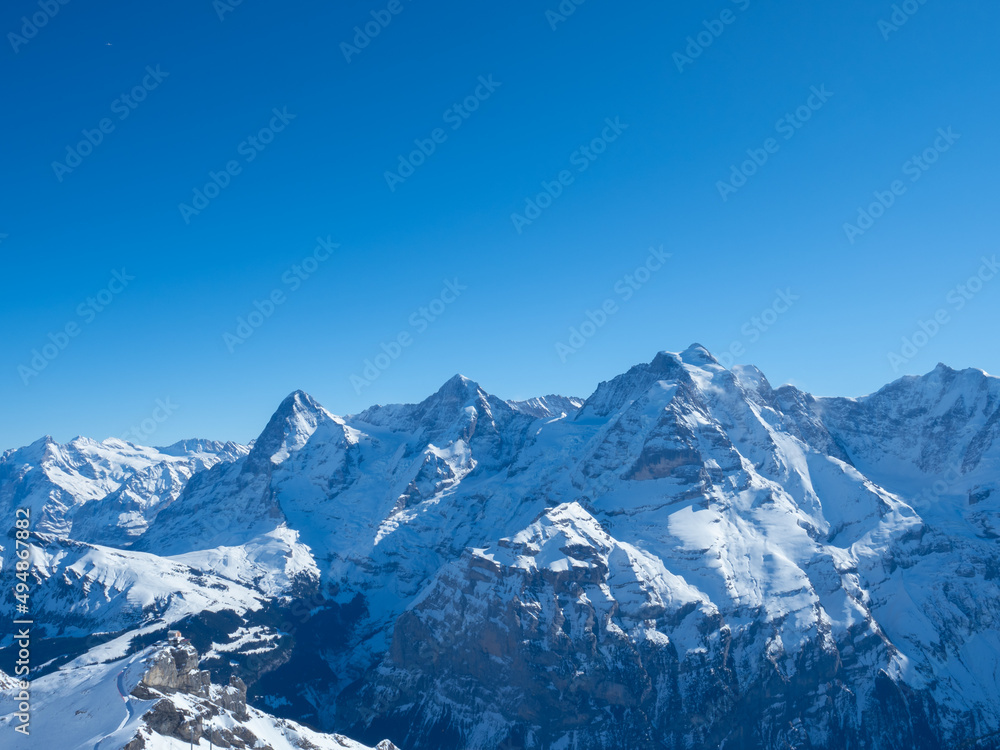 Obraz premium Winter view from Schilthorn peak, Switzerland, towards the famous mountains Eiger, Moench, and Jungfrau