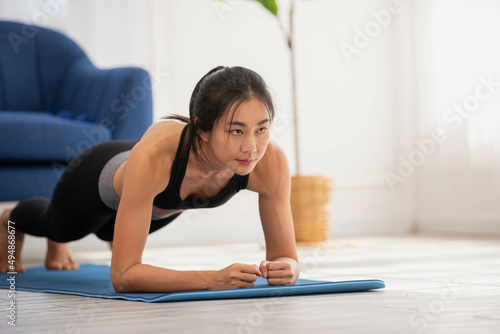 phalankasana, Plank posture, working out, wearing sportswear, Asian woman practicing yoga, performing push ups or press ups activity.