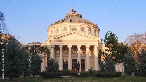 Romanian Athenaeum, a landmark in Bucharest, Romania. Hyperlapse of shadows across the neoclassical ornated facade of this domed, circular building, opened in 1888. photo