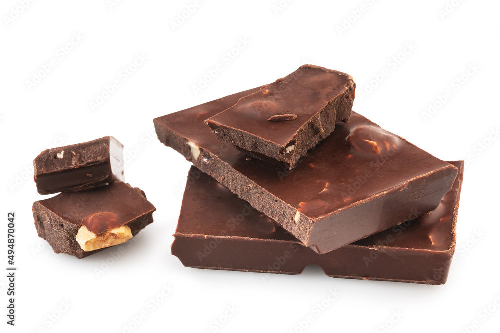 Pieces of dark chocolate bars with nuts isolated on a white background Pieces of dark chocolate bars with nuts isolated on a white background