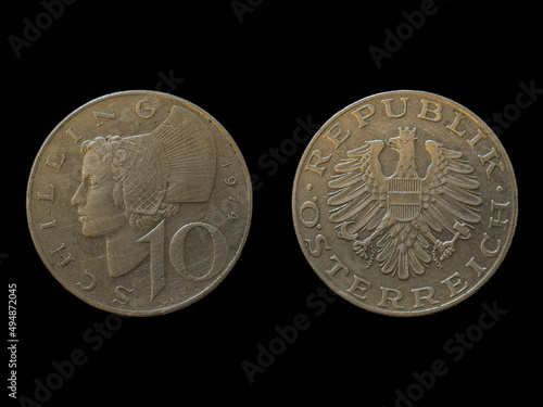 Close-up shot of 10 Austrian schilling coins isolated on 
 the black background photo