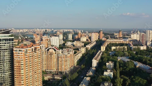 Aerial drone video of downtown apartment buildings and cars on the highway in Pecherskyi district of Kyiv Oblast Ukraine during sunset. Filmed on a summer day in August 2021 photo
