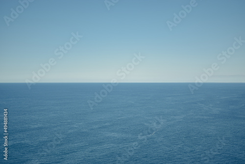 Sea horizon. Coastline. The blue of the sea meets the blue of the sky. Perfect symmetry.