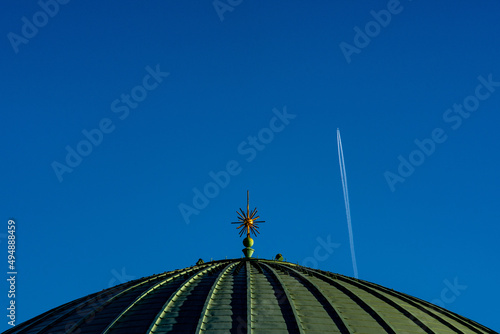 Dome under blue sky with chemtrails