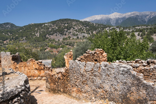 The ruins of the abandoned village of Aradena located over the wild gorge at the height of 138m. White Mountains on the background,  Sfakia, Region of Chania, Crete, Greece
 photo