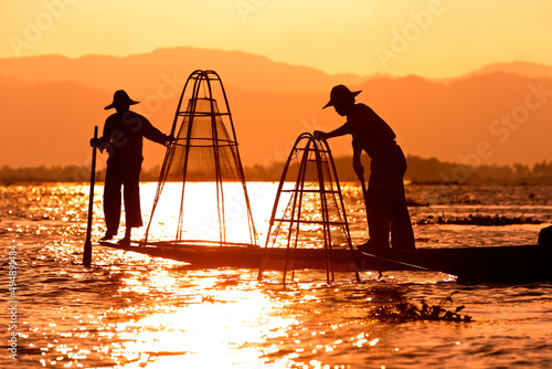 Fishermen in boats with traditional Intha conical nets in Myanmar photo