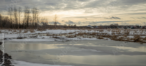 European landscape in March  snow begins to melt on the fields. Evening landscape in early spring.