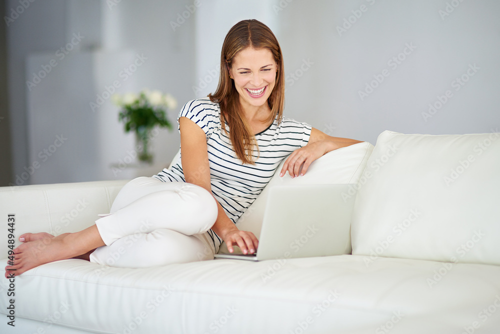 Enjoying crystal clear chatting. Shot of a young woman browsing the internet at home. Enjoying crystal clear chatting. Shot of a young woman browsing the internet at home.