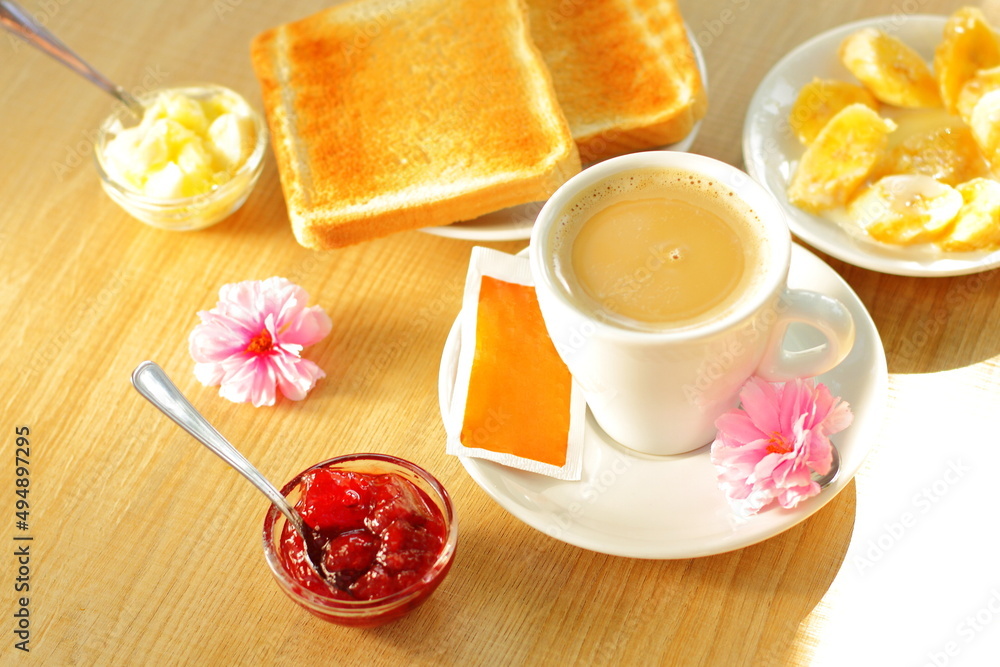 Toasted bread, butter and cup of coffee for breakfast Toasted bread, butter and cup of coffee for breakfast