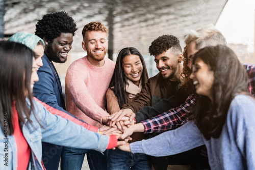 Slika na platnu Young multiracial friends stacking hands together outdoor - Friendship and diver