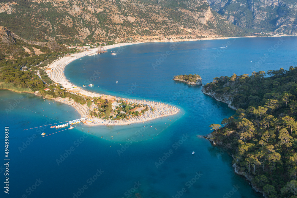 view to curved shape of sandbar and forests on cliff in Turkey