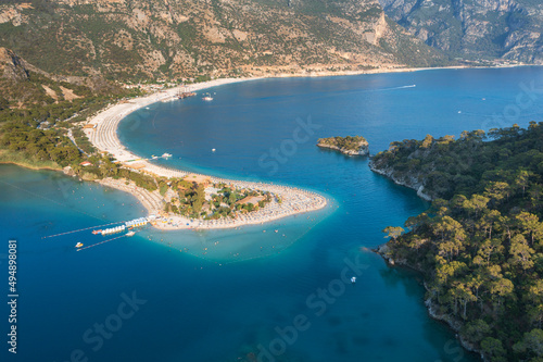 view to curved shape of sandbar and forests on cliff in Turkey