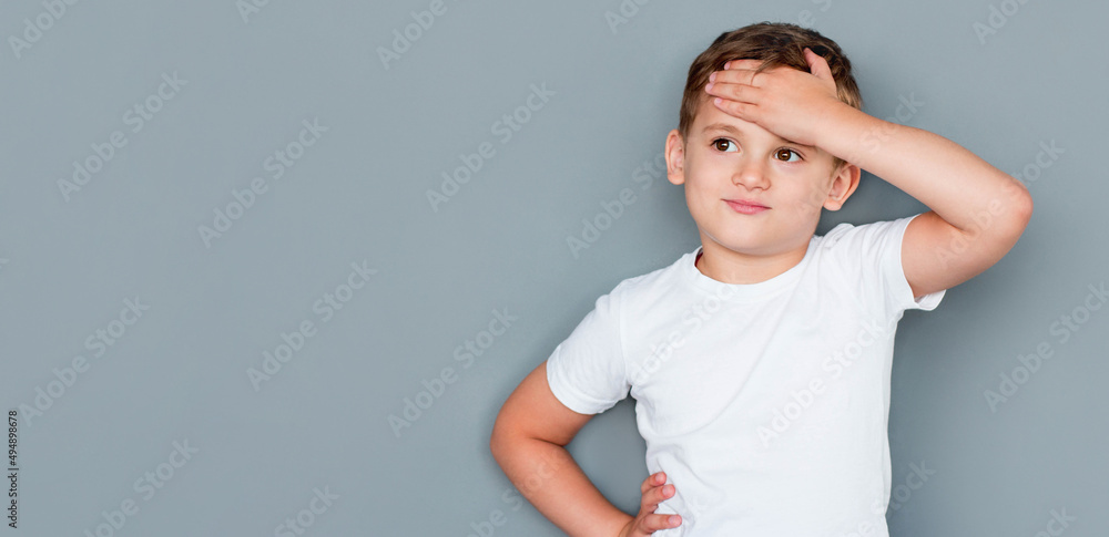 childhood, expressions and people concept - little boy in white t-shirt facepalming over grey background childhood, expressions and people concept - little boy in white t-shirt facepalming over grey background