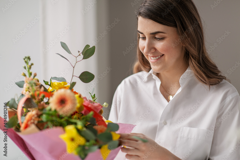 people, gardening and floral design concept - happy smiling woman or floral artist with bunch of flowers at home people, gardening and floral design concept - happy smiling woman or floral artist with bunch of flowers at home