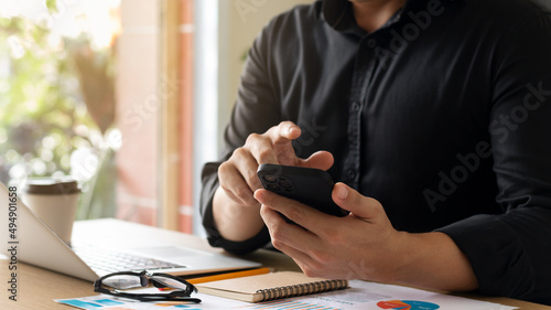 businessman working using mobile phones and laptop computers Liaise with customers and plan business strategies, working concepts using technology in the most efficient way.