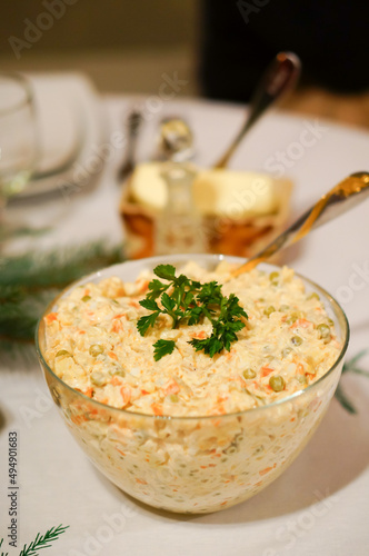 Vertical shot of a traditional polish christmas salad in a glass jar photo