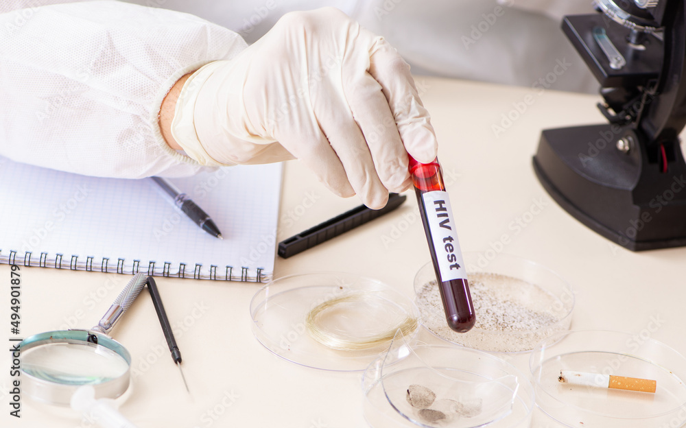 Young expert criminologist working in the lab Young expert criminologist working in the lab
