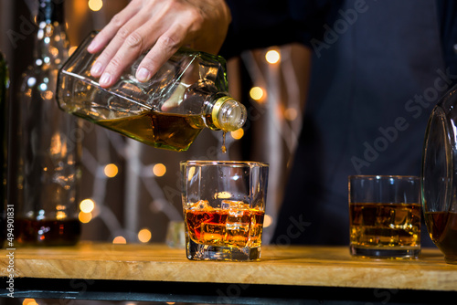 Bartender Serve Whiskey  on wood bar  
