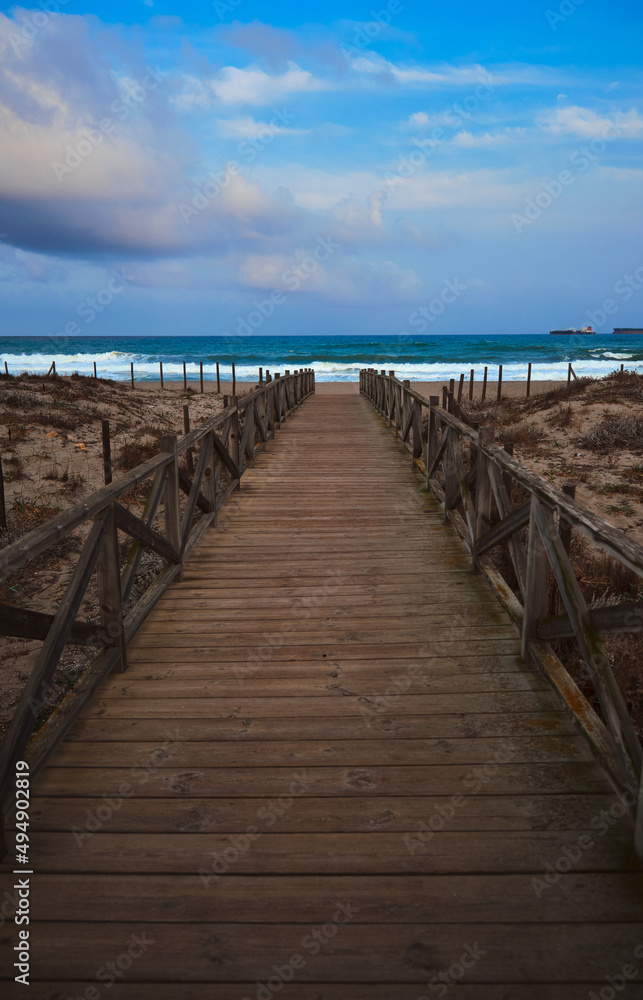 Wooden bridge to access the beach of Gibraltar. In vertical