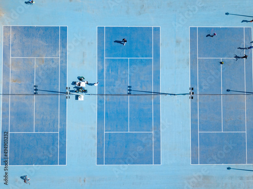Blue tennis court in the city. Aerial drone top view.