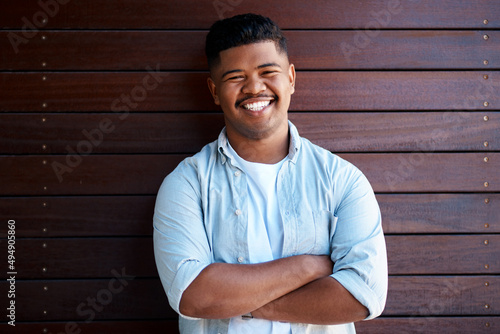 Positivity is best paired with ambition. Portrait of a confident young businessman working in a modern office.