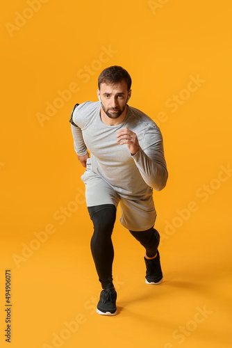 Sporty male runner on color...