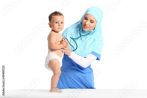 Muslim pediatrician examining baby boy on white background