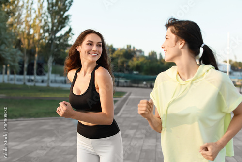 Beautiful young women runni...