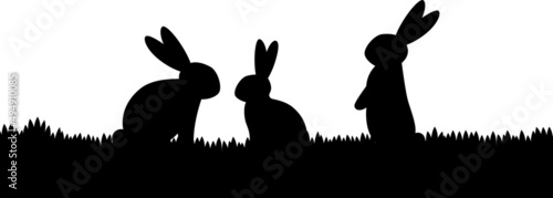 silhouette of three rabbits on the grass, black vector illustration on white background