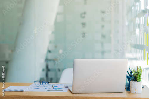 Wallpaper Mural Wooden desk with laptop and papers, books, modern interior. A desk for business people or students at home. comfortable workspace working with computers in the office Torontodigital.ca