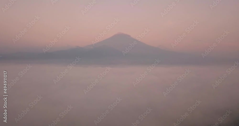 aerial drone view of Mountain with dense fog in the morning, landscape videos, amazing mountains In Indonesia at sunrise aerial drone view of Mountain with dense fog in the morning, landscape videos, amazing mountains In Indonesia at sunrise