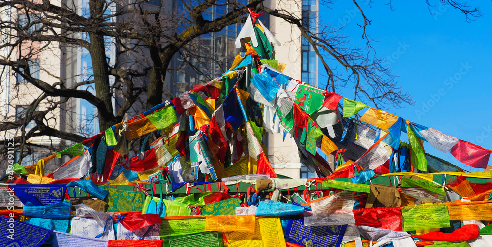 Buddhist prayer flags lungta with Buddhist mantra prayer in yard of Datsan Gunzechoinei, Saint Petersburg, Russia