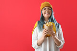 Young woman with unusual hair and french fries on color background