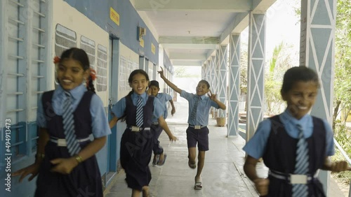 cheerful students running at school corridor for going to classroom - concept of education, childhood excitement and knowledge