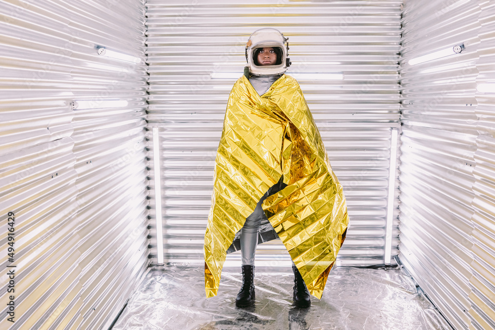 Black astronaut wrapped in emergence blanket Black astronaut wrapped in emergence blanket
