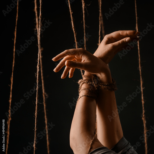 tied female hands with a string