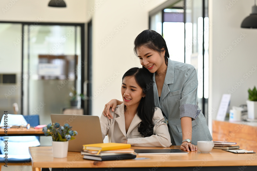 A portrait of happy Asian businesspeople sitting in the office looking at the tablet together, for business and technology concept. A portrait of happy Asian businesspeople sitting in the office looking at the tablet together, for business and technology concept.