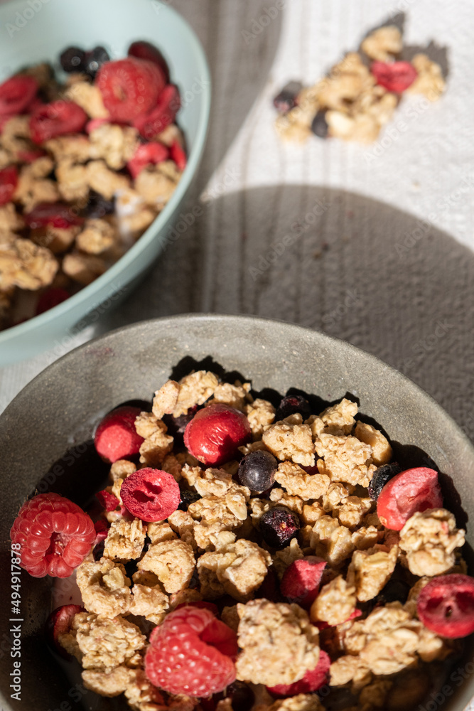 Bowl with muesli and berries on table for breakfast Bowl with muesli and berries on table for breakfast