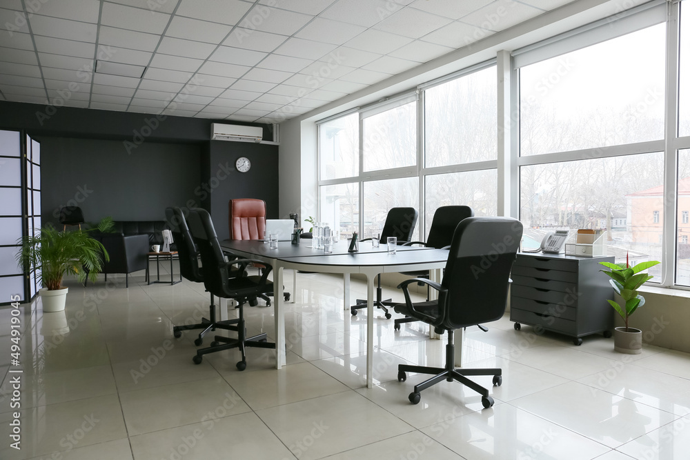 Stylish interior of conference hall with table and chairs